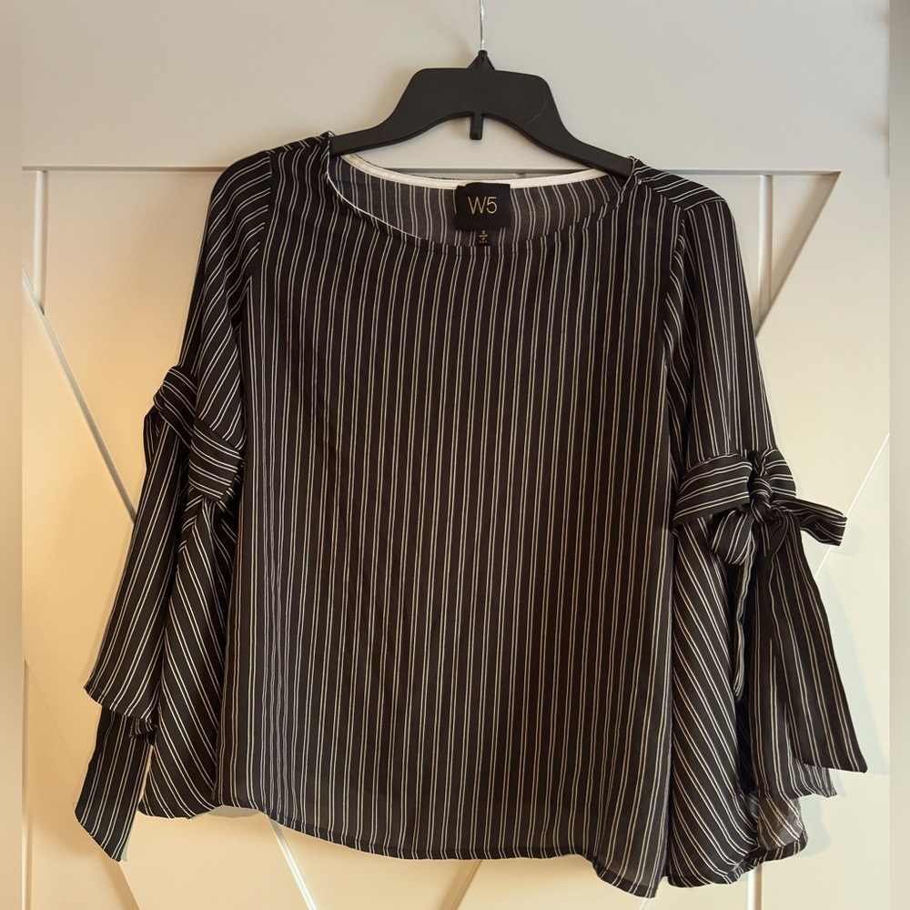 Women’s size small black and ivory blouse. Super cute bow details on arms.